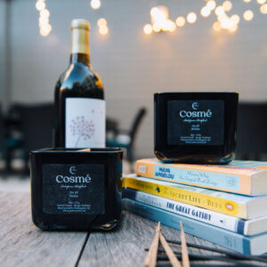 A bottle of wine and a box of cigarettes sit on the table.