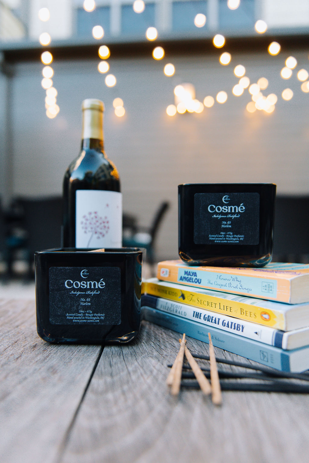 A bottle of wine and a box of cigarettes sit on the table.