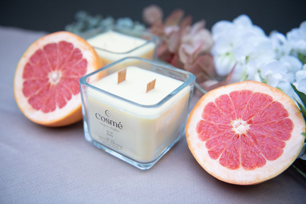 A bowl of freshly-picked citrus fruits, including grapefruit, orange, and citron, sits invitingly indoors, inviting one to enjoy the natural goodness of these delicious fruits.